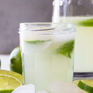 A refreshing glass of limeade with slices of fresh lime.