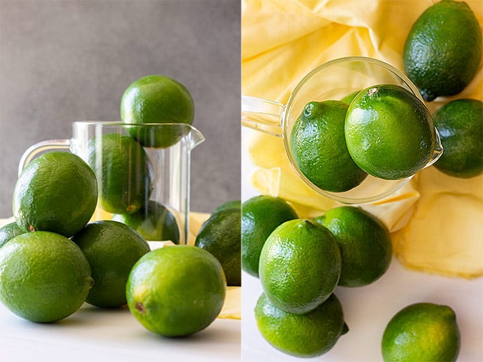 Limes for limeade scattered with a yellow napkin in the background. 