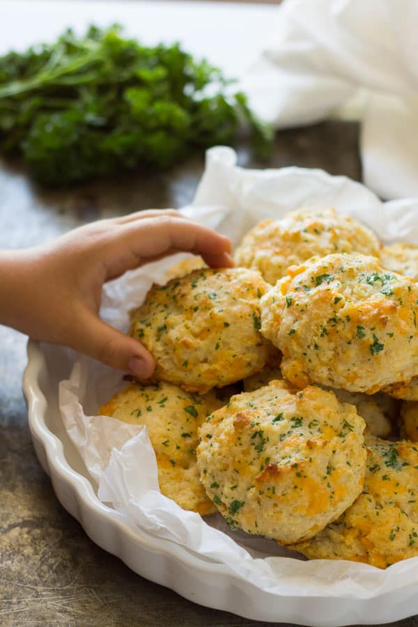 hand reaching for garlic cheese biscuit