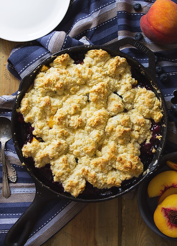 Blueberry Peach Cobbler -an easy recipe made with fresh peaches and blueberries baked beneath a fluffy biscuit topping! | www.countrysidecravings.com