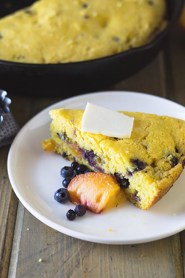 Blueberry Peach Cornbread made with buttermilk, studded with fresh blueberries and peaches will be your new favorite breakfast treat! | www.countrysidecravings.com