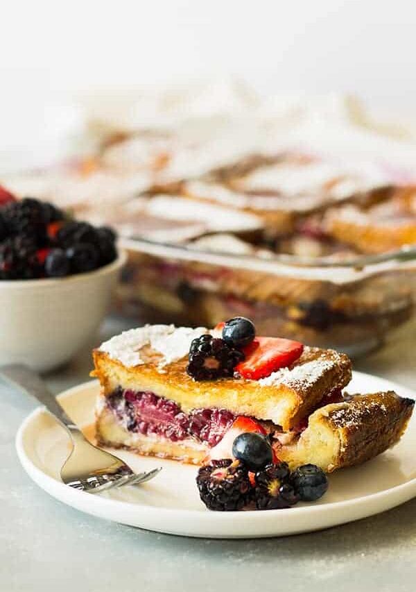Triple Berry French Toast Casserole -an easy yet impressive breakfast casserole. Layered with thick texas toast, cream cheese, fresh berries and an egg custard! | www.countrysidecravings.com