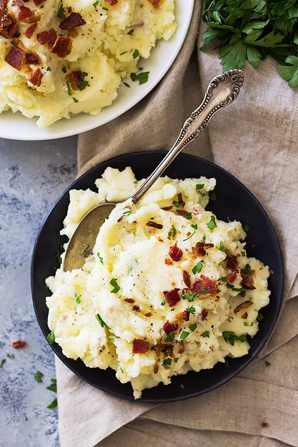 Bacon Mashed Potatoes are creamy, fluffy and full of flavor! Studded with crispy bacon, green onions and made ultra decadent with a little cream cheese. | www.countrysidecravings.com