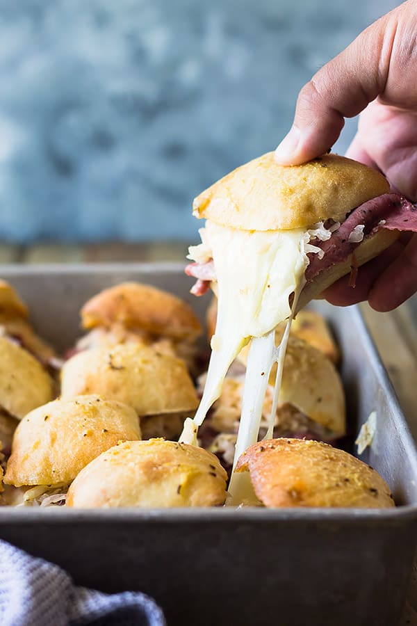 These easy Reuben Sliders make a great appetizer, snack or meal! Piled high with all the fixings they will definitely be a hit! | www.countrysidecravings.com 