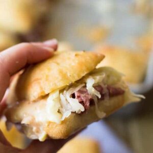 These easy Reuben Sliders make a great appetizer, snack or meal! Piled high with all the fixings they will definitely be a hit! | www.countrysidecravings.com