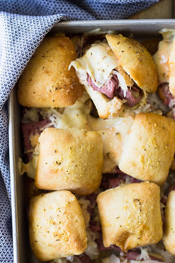 These easy Reuben Sliders make a great appetizer, snack or meal! Piled high with all the fixings they will definitely be a hit! | www.countrysidecravings.com 