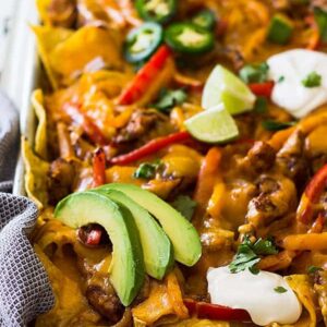 This Sheet Pan Chicken Fajita Nachos is a great game day appetizer for a crowd! Filled with seasoned chicken and vegetables and lots of cheese! | www.countrysidecravings.com