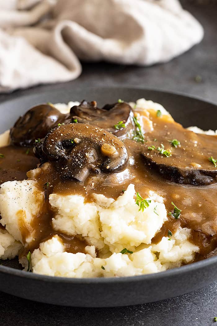 Close up of gravy over mashed potatoes. 