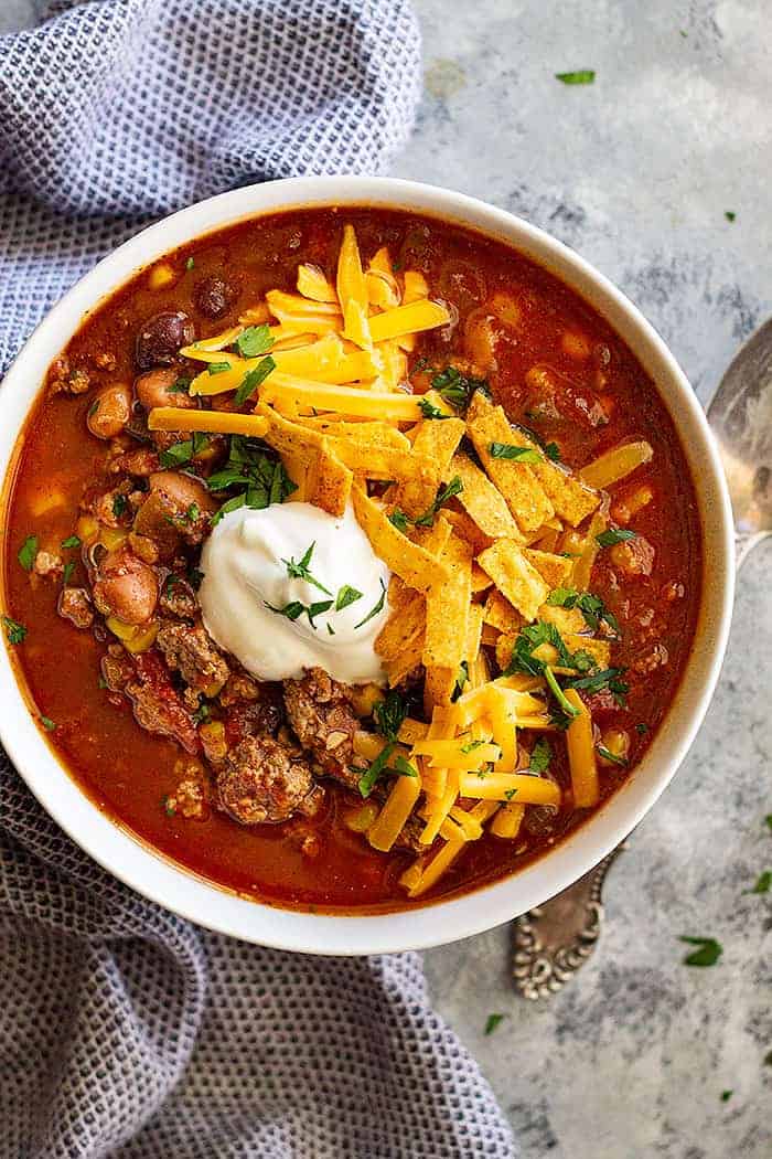 This Easy Taco Soup can be made in 30 minutes or less! Or make it in the slow cooker and come home to a delicious hearty meal! #soup #easy #taco #healthy