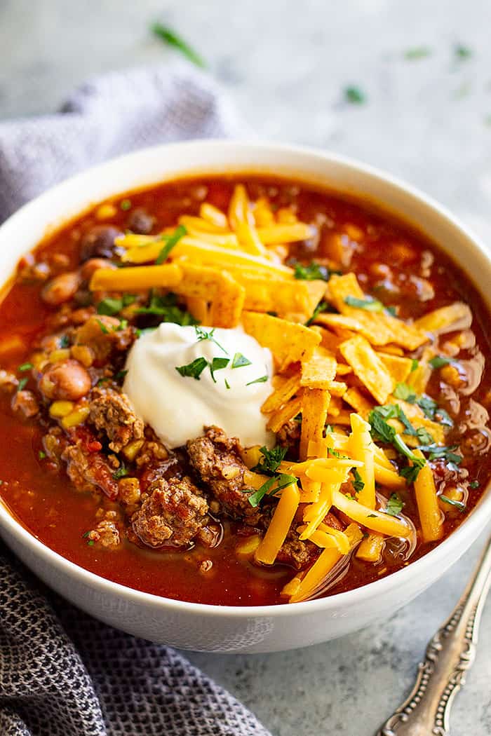 This Easy Taco Soup can be made in the slow cooker or on the stovetop (which only takes 30 minutes!). It's hearty, full of flavor, healthy, and great for any day of the week! #crockpot #soup #easy #beef