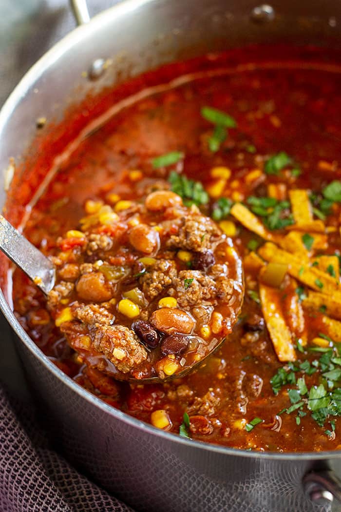 This Easy Taco Soup is a great weeknight meal! It only takes 30 minutes to make or you can use your slow cooker to do the work for you. It's hearty, full of flavor, and perfect for any night of the week! #crockpot #soup #beef #taco