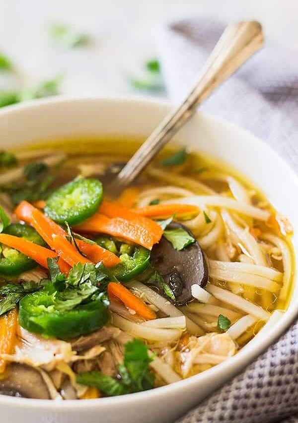 This Slow Cooker Asian Chicken Noodle Soup puts a twist on the classic. With a flavorful broth, mushrooms, ginger, garlic and noodles! | www.countrysidecravings.com