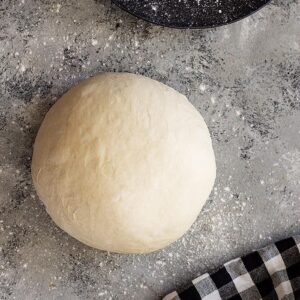 A ball of dough ready to roll into a crust.