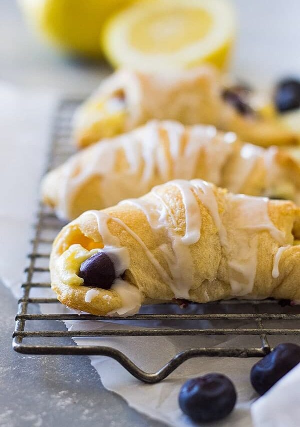 These Lemon Blueberry Cheesecake Crescent rolls is an easy recipe using store bought crescent dough. Combine that with lemon and blueberries and you have one sweet treat!