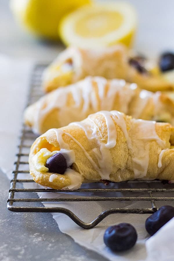These Lemon Blueberry Cheesecake Crescent rolls is an easy recipe using store bought crescent dough. Combine that with lemon and blueberries and you have one sweet treat!