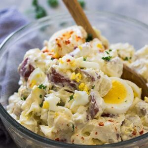 This Old Fashioned Potato Salad is made with mayonnaise, sour cream and hard boiled eggs. It's the perfect compliment to any bbq!