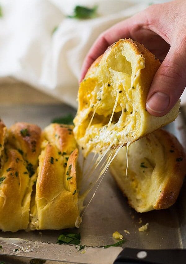 This Three Cheese Braid is filled with melted mozzarella, cheddar and Parmesan cheese. Then baked in a golden crust and brushed with butter and garlic!