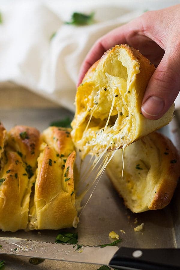 This Three Cheese Braid is filled with melted mozzarella, cheddar and Parmesan cheese. Then baked in a golden crust and brushed with butter and garlic!