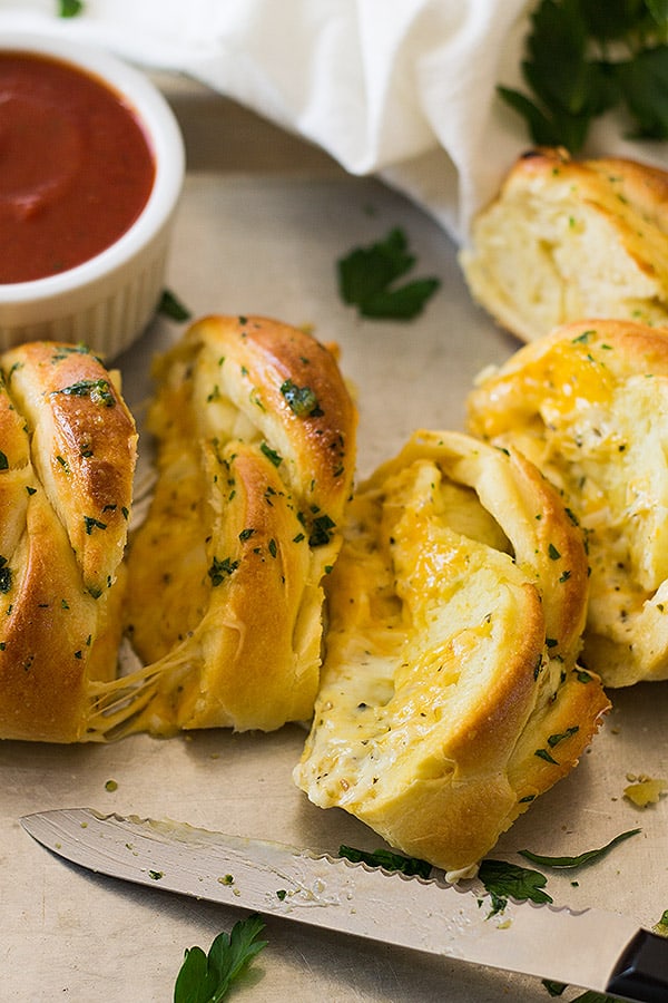 This Three Cheese Braid uses homemade pizza crust to wrap up three cheeses. Baked until gooey and brushed with melted butter and garlic!
