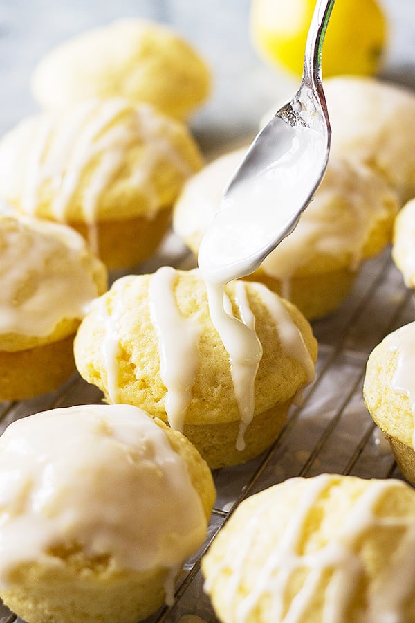 drizzling lemon glaze on lemon muffins