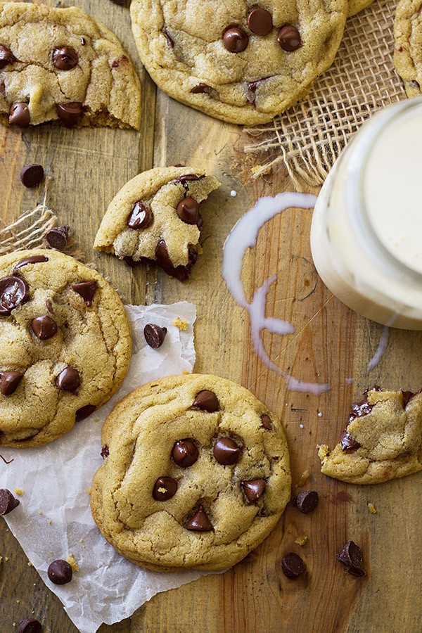 Top view of no chill soft chocolate chip cookies on wooden table with milk 