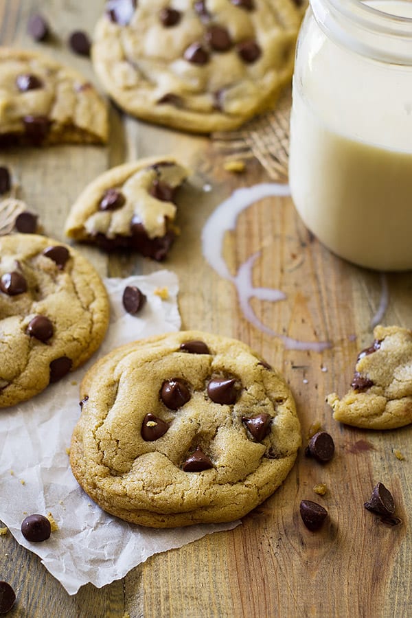 View of no chill soft chocolate chip cookies on wooden surface with milk