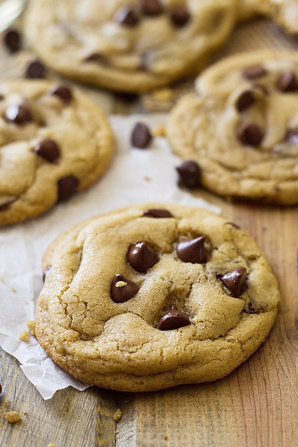 Close view of chocolate chip cookies on wooden surface