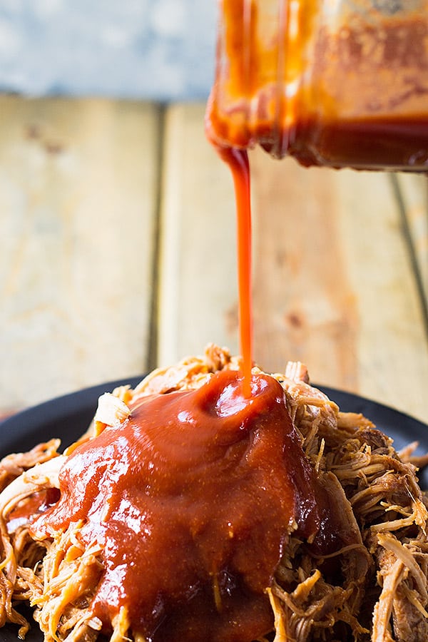 adding homemade barbecue sauce to meat