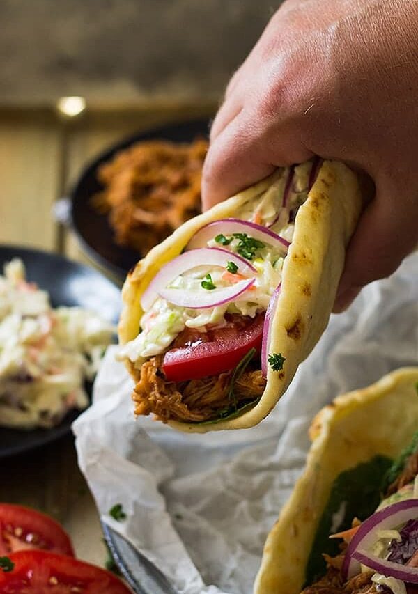 hand holding bbq pulled pork gyro