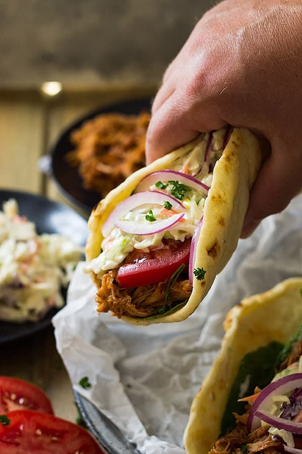 hand holding bbq pulled pork gyro