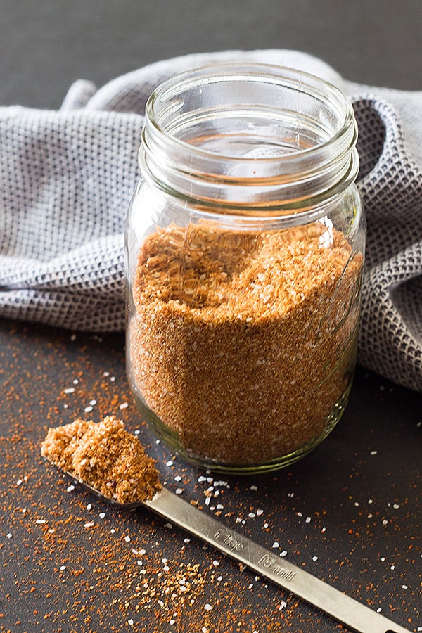 Mason jar filled with homemade spice dry rub recipe for ribs or pork