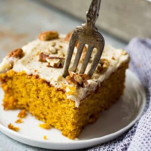 This Easy Pumpkin Cake with Cream Cheese Frosting is a lot easier than a pumpkin cake roll but tastes just like it! It's moist, full of pumpkin spice, topped with a dreamy cream cheese frosting and perfect for fall!
