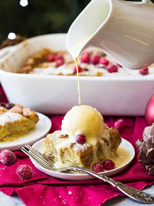 This Cranberry Bread Pudding with Whiskey Cream Sauce is an indulgent dessert! Brioche bread baked in a cinnamon custard then topped with a whiskey cream sauce!