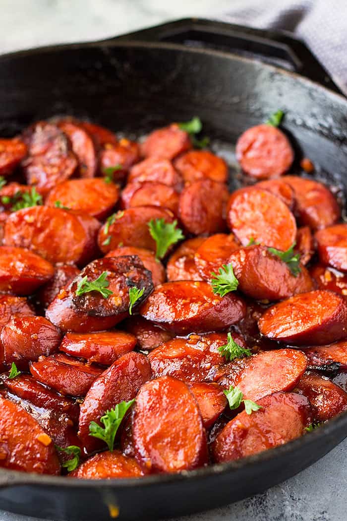 side view of smoked sausage in a skillet