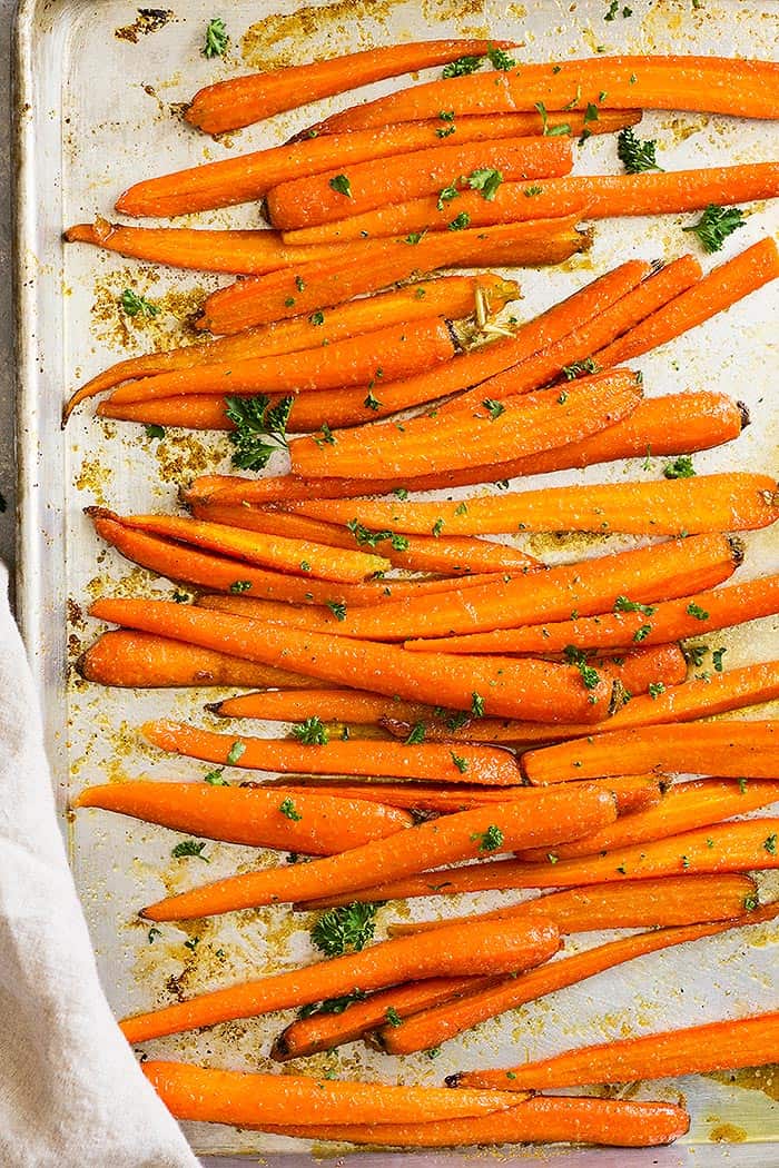 Top down view of honey garlic roasted carrots on a sheet pan