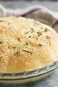Close up of a round loaf of rosemary parmesan bread.