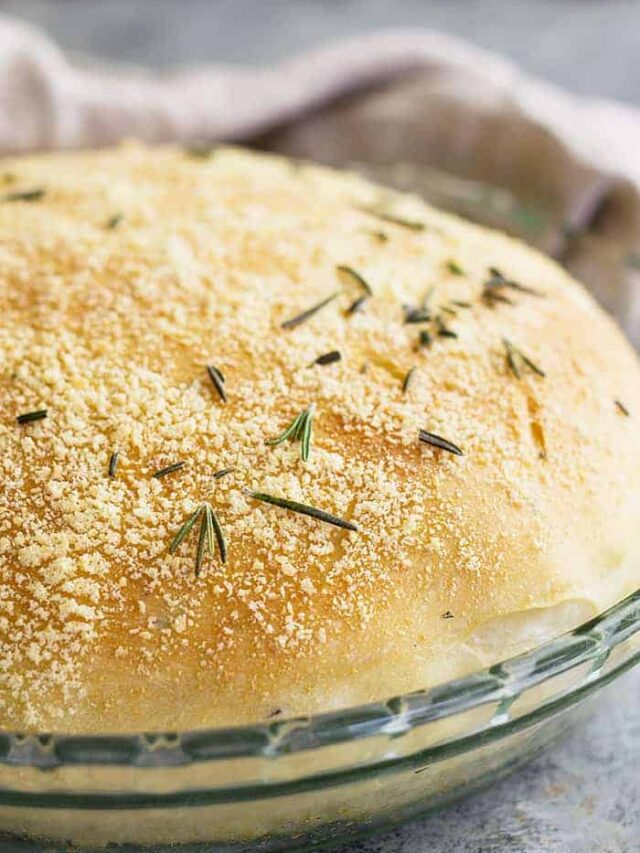 Close up of a round loaf of rosemary parmesan bread.