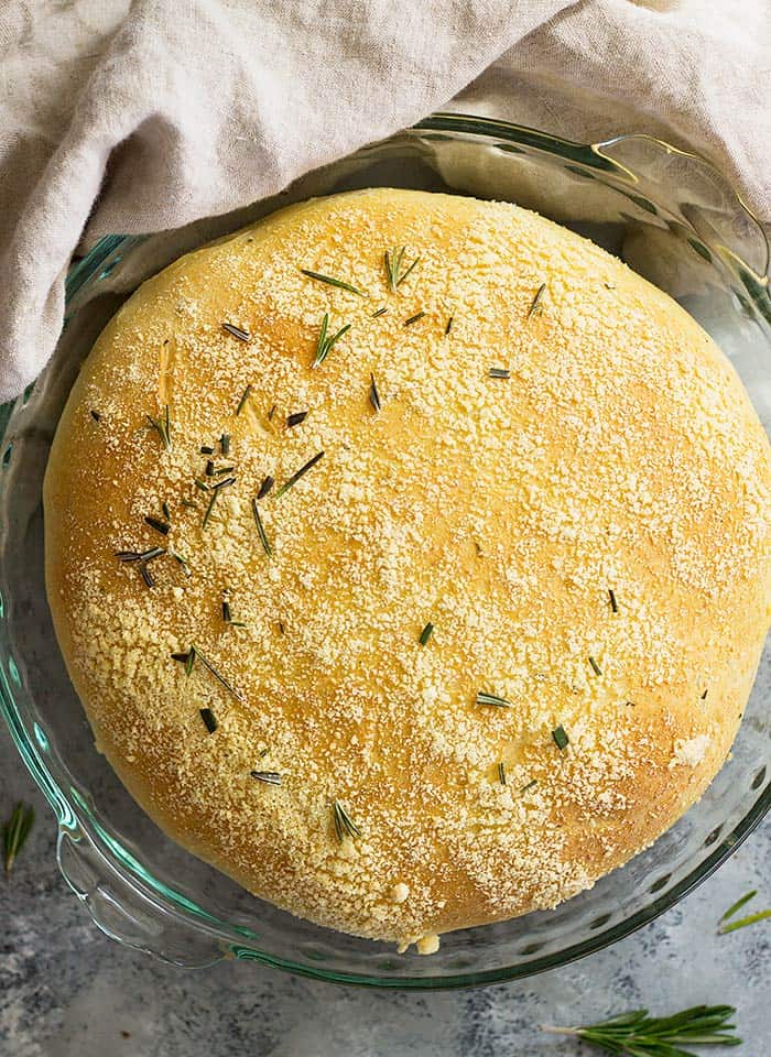 Top down view of a round loaf of rosemary parmesan bread. 