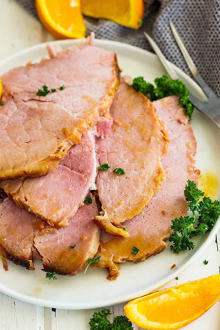 Close up picture of sliced Slow Cooker Honey Mustard Glazed ham on a plate.
