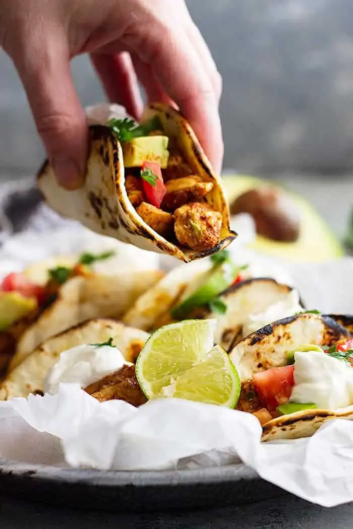 hand holding a spicy chicken taco