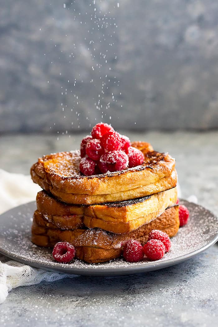 Raspberry Cheesecake Stuffed French Toast -a great brunch recipe for any special occasion! Rich and buttery brioche bread stuffed with raspberry cheesecake and drizzled with hot fudge sauce. Pure decadence for breakfast! 