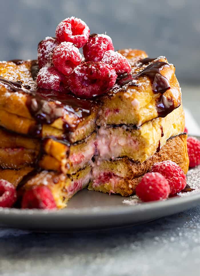 Raspberry Cheesecake Stuffed French Toast -a rich and decadent breakfast for any special occasion! Fresh raspberries mixed with cream cheese stuffed between rich brioche bread makes a special treat! 