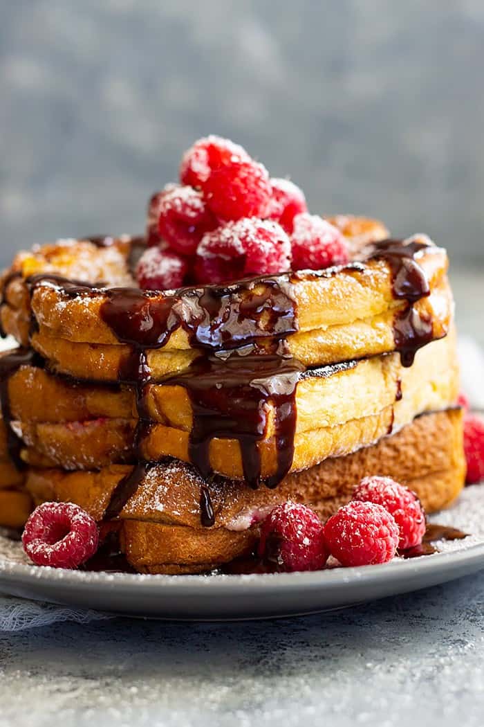 Raspberry Cheesecake Stuffed French Toast -is a very special brunch or breakfast! Buttery brioche bread stuffed with raspberry cheesecake filling then drizzled with hot fudge sauce! It's like dessert for breakfast!