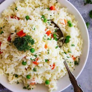 Easy Rice Pilaf with Carrots and Peas is a quick and easy side dish that pairs well with so many dishes! Great for casual weeknight dinners or for company.