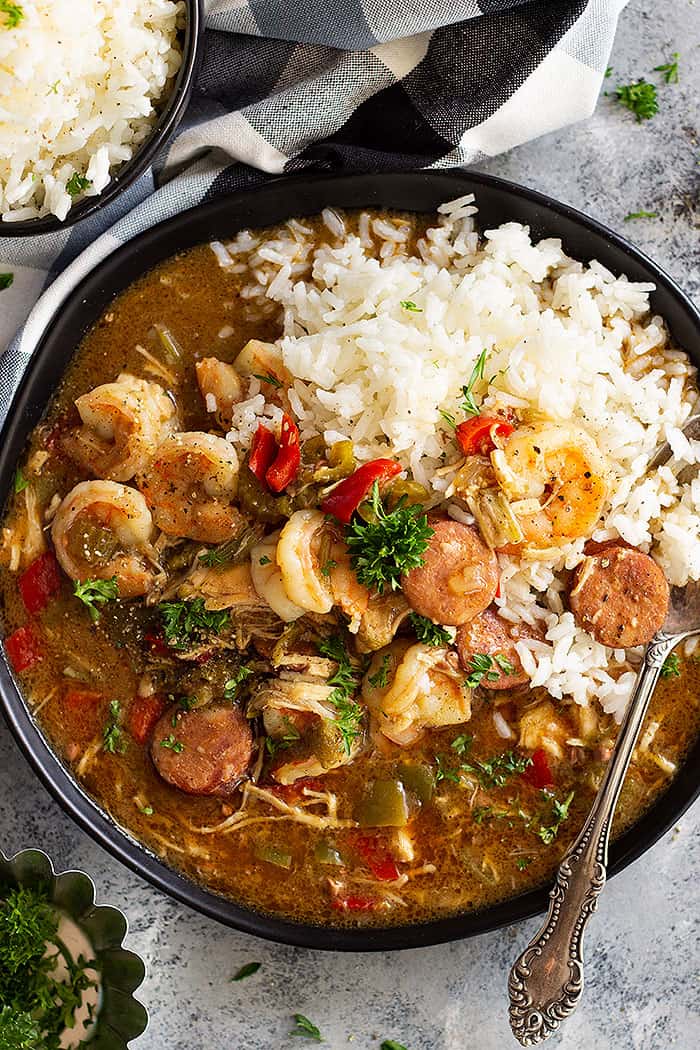 Slow Cooker Chicken, Sausage, and Shrimp Gumbo is a wonderfully hearty meal made easy with the crockpot! This New Orleans inspired dish is full of flavor and feeds a crowd!