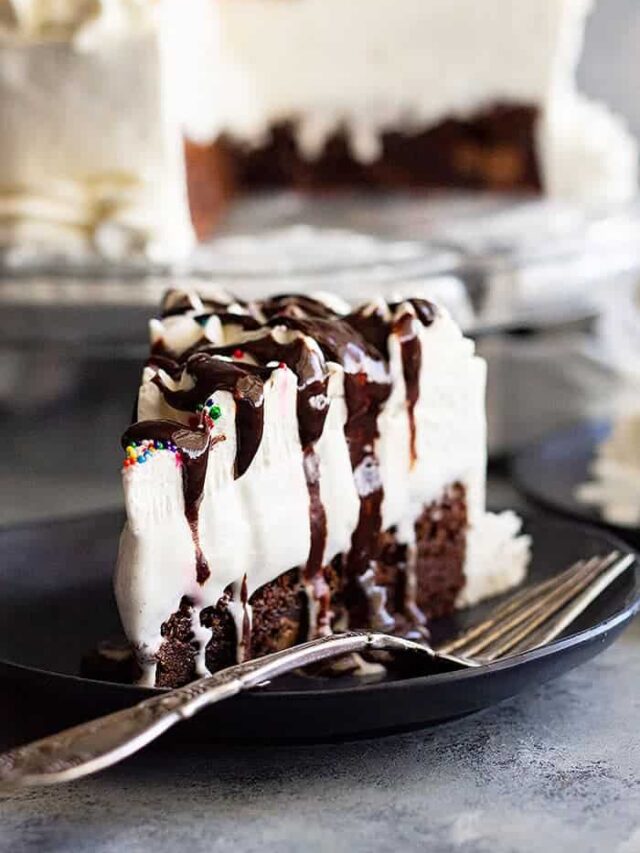 This Brownie Ice Cream Cake is an easy way to impress your guests. Chewy brownie on the bottom, topped with hot fudge sauce, vanilla ice cream, and a homemade whipped cream topping. #brownie #icecream #cake