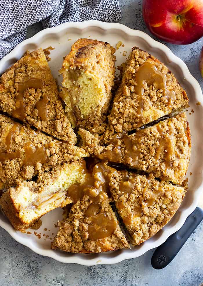 This Apple Crumb Cake is the perfect fall treat! It's filled with spiced apples, an extra thick crumb layer, and a tender cake. Drizzle with an easy homemade caramel sauce for the perfect treat! #apple #cakerecipes #easyrecipe #applecake