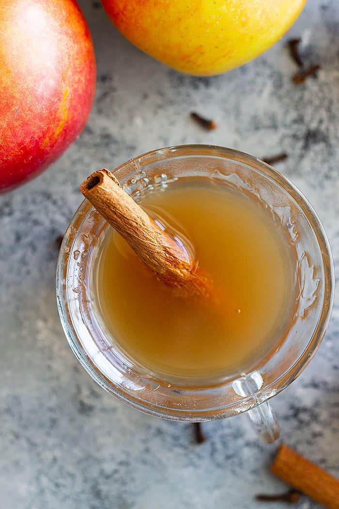 Homemade Apple Cider that's filled with warm spices like cinnamon, allspice, and a little clove. It's the perfect drink to warm up with! Slow cooker, Instant Pot, and stove top instructions included. #apples #applecider #easyrecipe #beverage