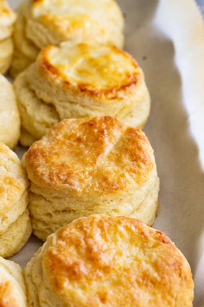 Golden, flaky buttermilk biscuits on a sheet pan. 