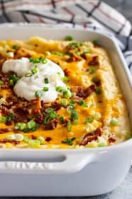 This Loaded Mashed Potato Casserole is the perfect make ahead side dish! It's filled with bacon and cheese and feeds a crowd! #loadedpotatoes #mashedpotatoes